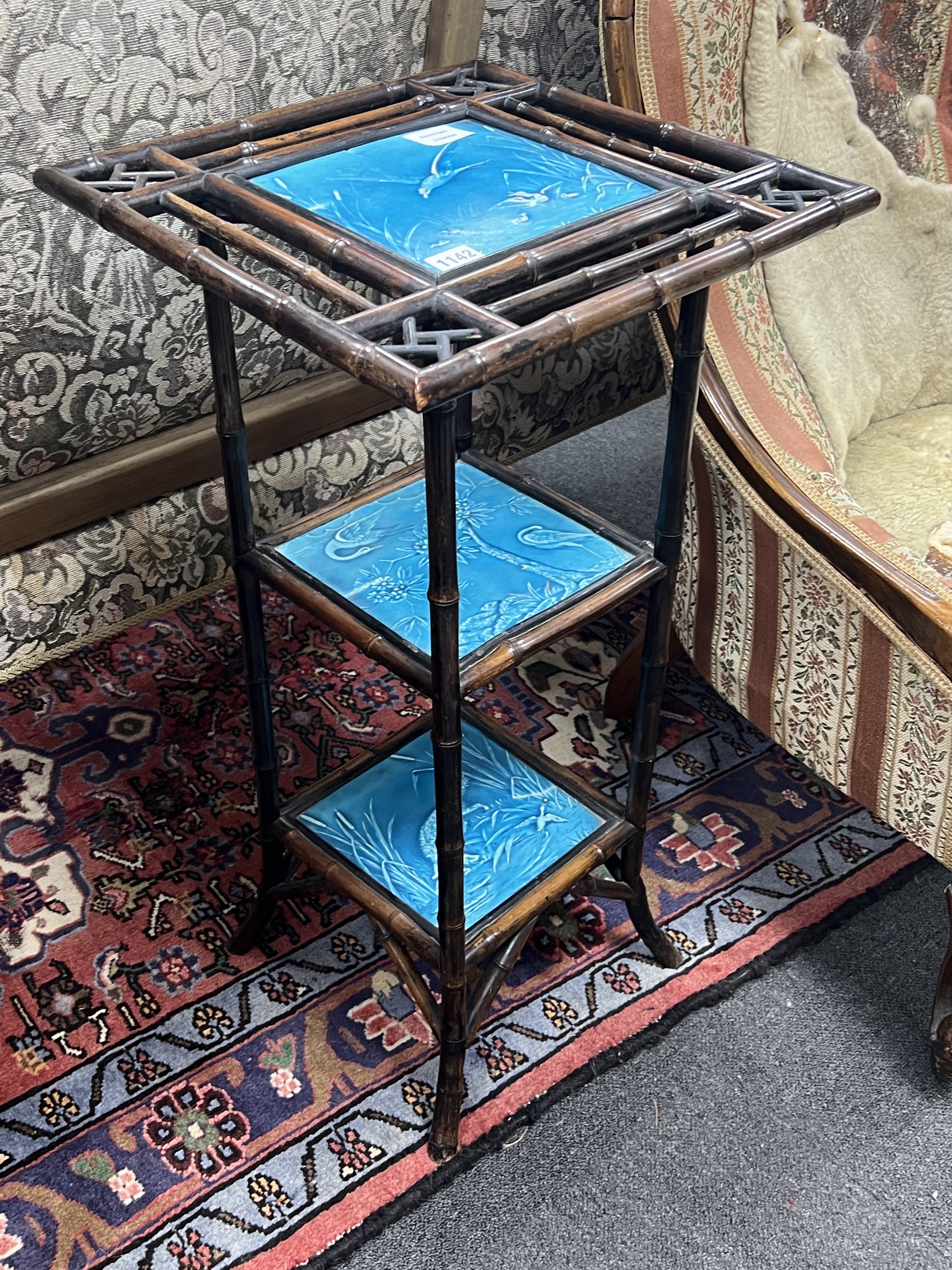 A Victorian Aesthetic movement bamboo and Minton tile inset three tier stand, width 38cm, height 76cm